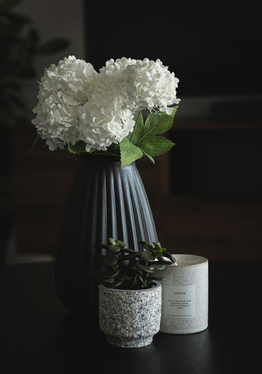 white flower in blue vase
