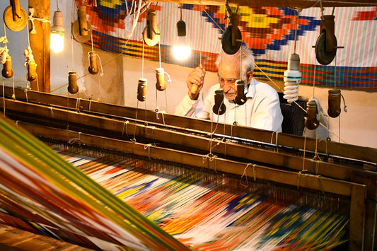 a man is working on a weaving machine
