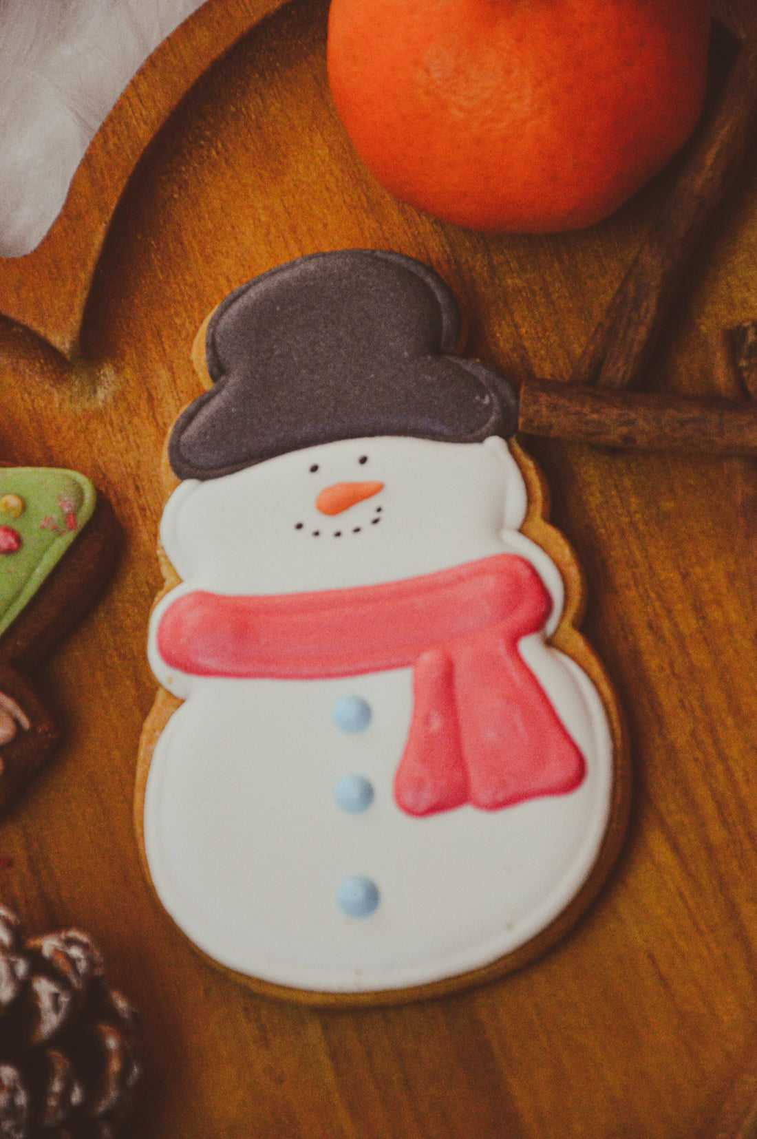 a cookie decorated like a snowman on a table