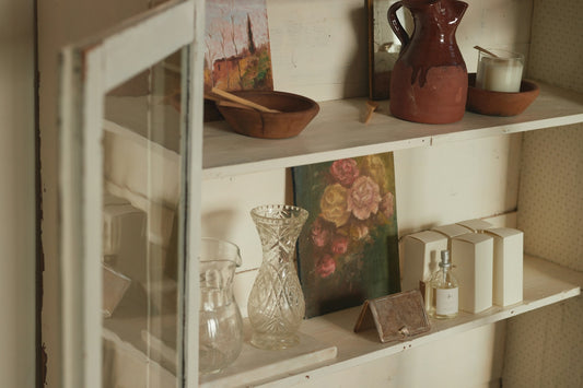 A shelf filled with vases and other items