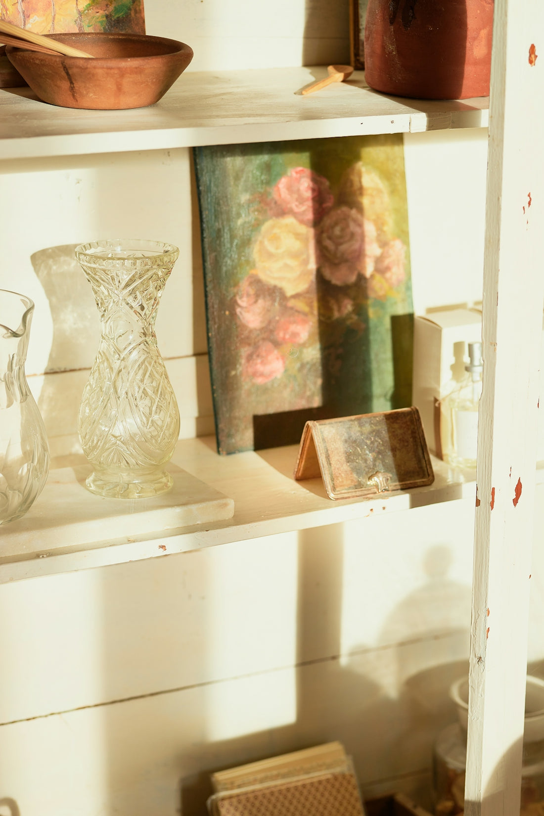 A shelf with vases and other items on it