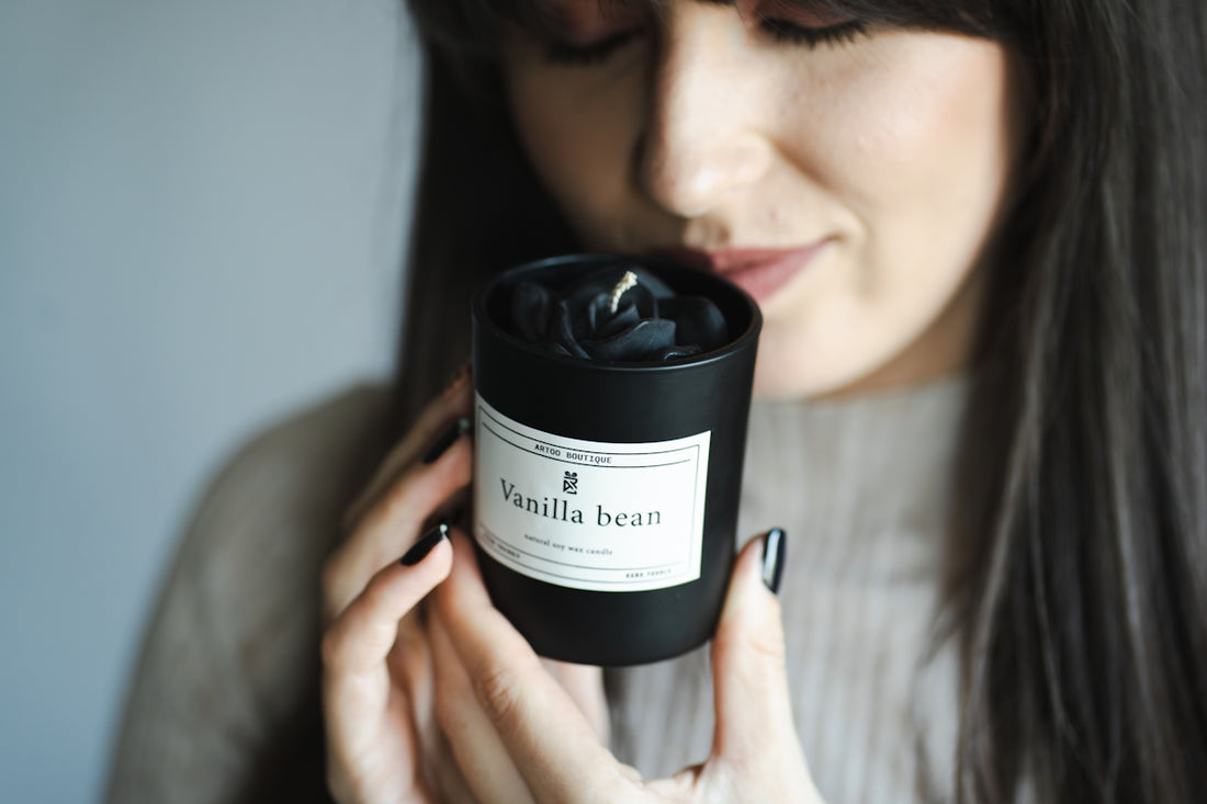 Woman smelling a vanilla bean scented candle.