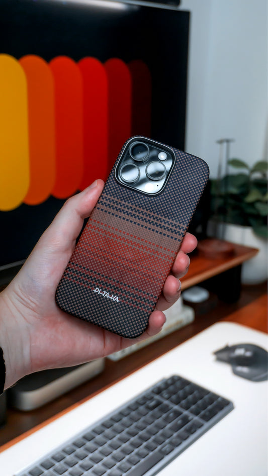 A hand holds a phone with a stylish patterned case.