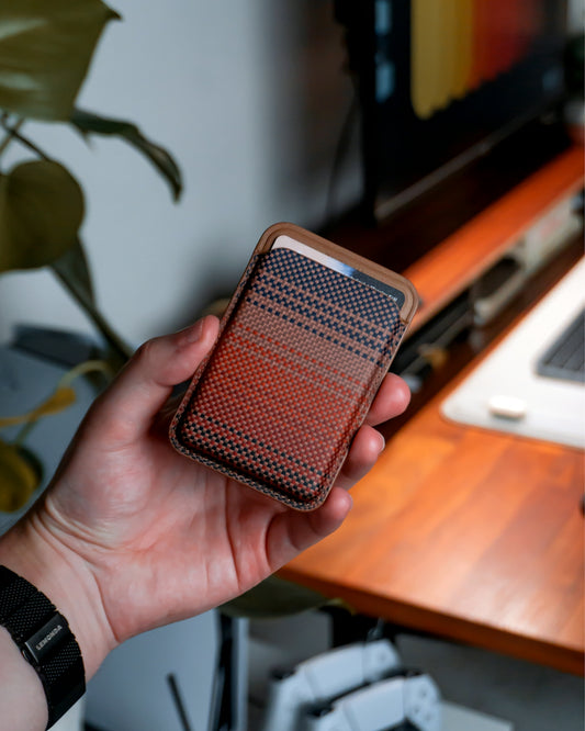 A person holds a phone case with a wallet.