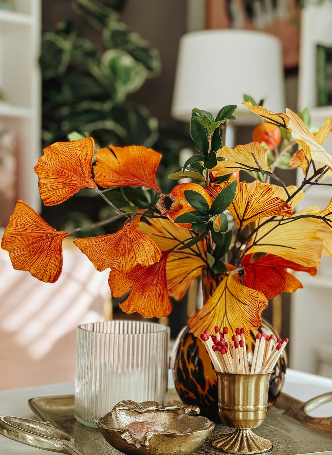 Orange and yellow leaves in a vase with matches