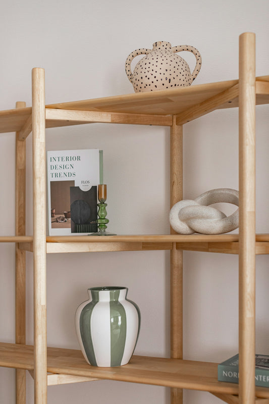 Wooden shelves display decorative items and books.