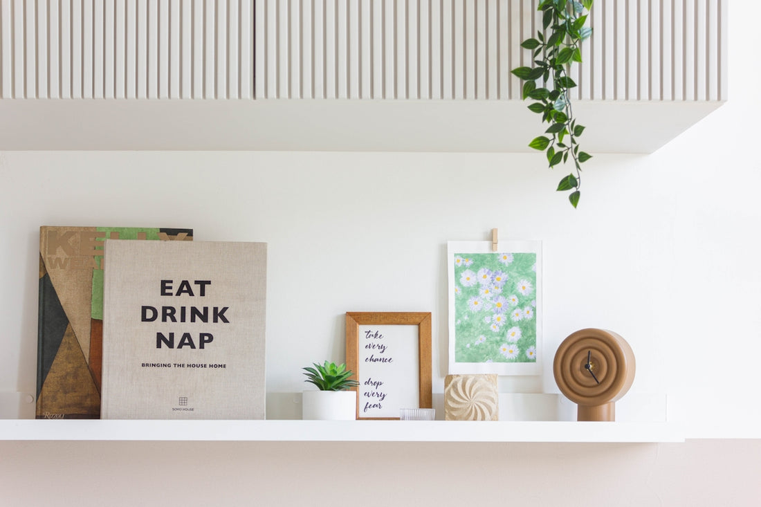 Shelf with books, art, and decor