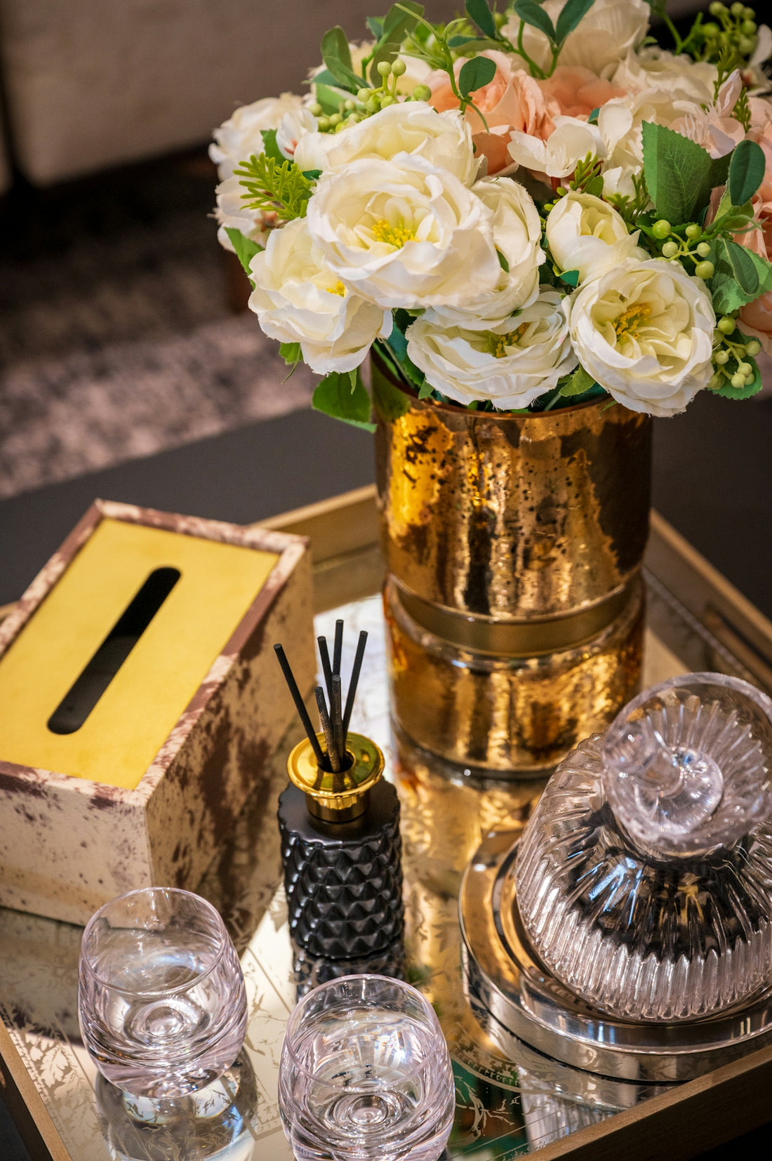 A decorative arrangement of flowers and home accessories.