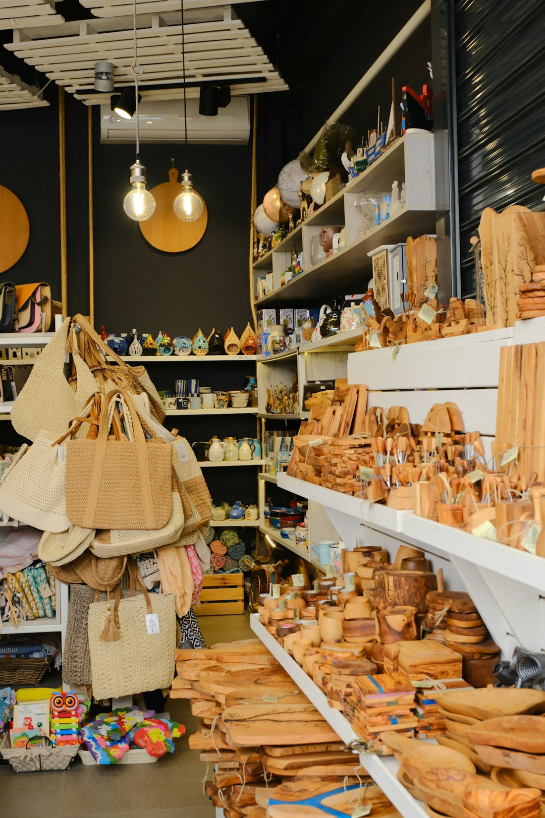 A shop interior filled with wooden crafts, bags, and souvenirs.